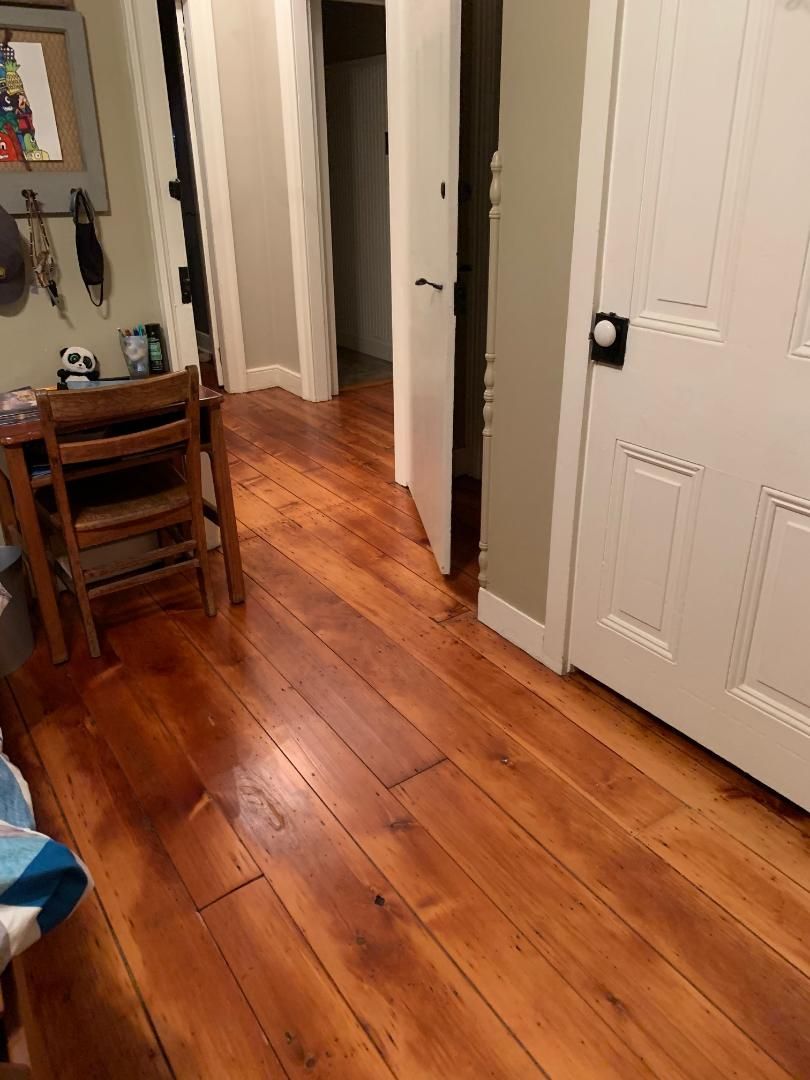 A room with hardwood floors and white doors
