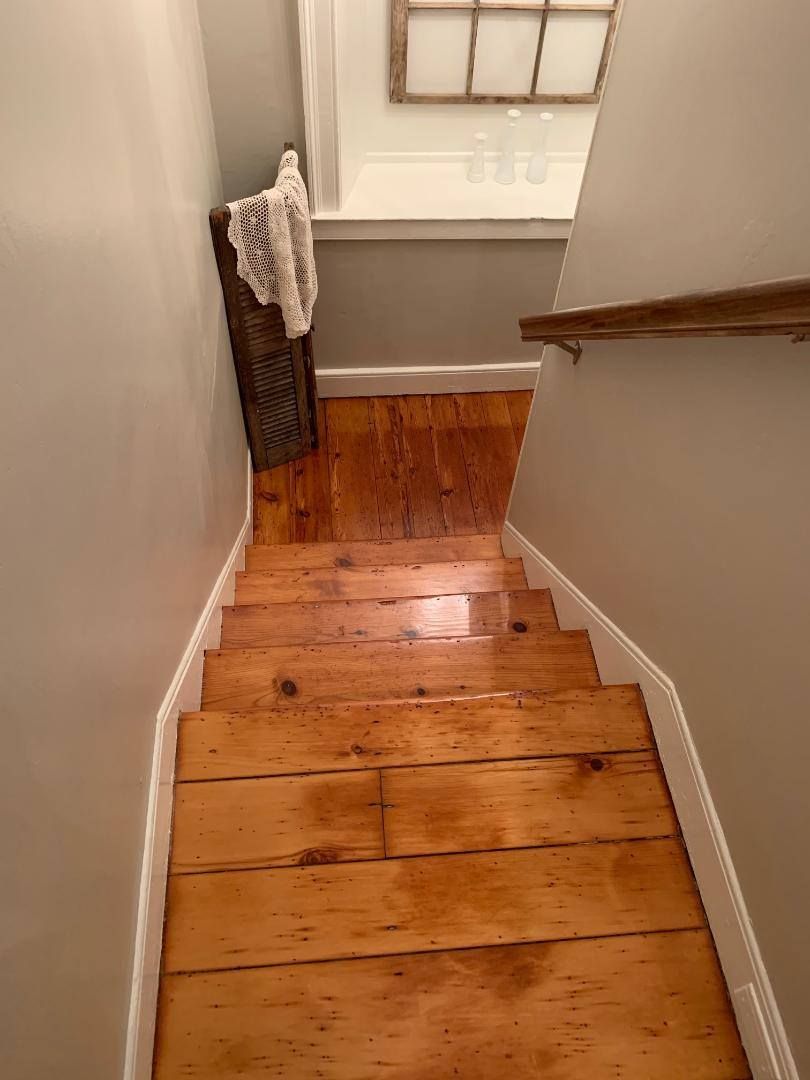 A set of wooden stairs leading up to the second floor