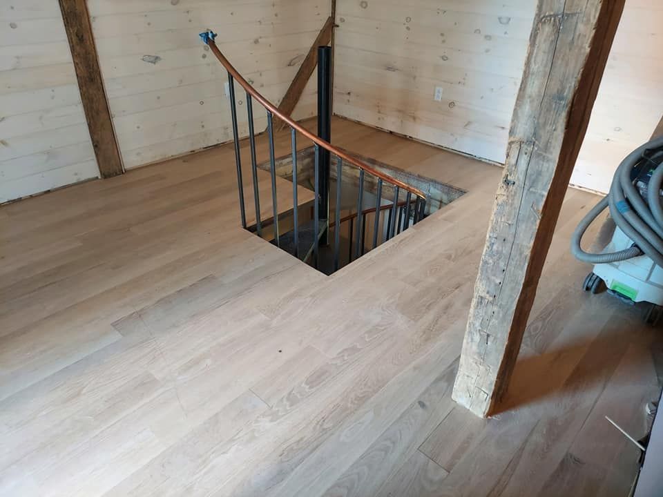 A spiral staircase in a room with wooden floors
