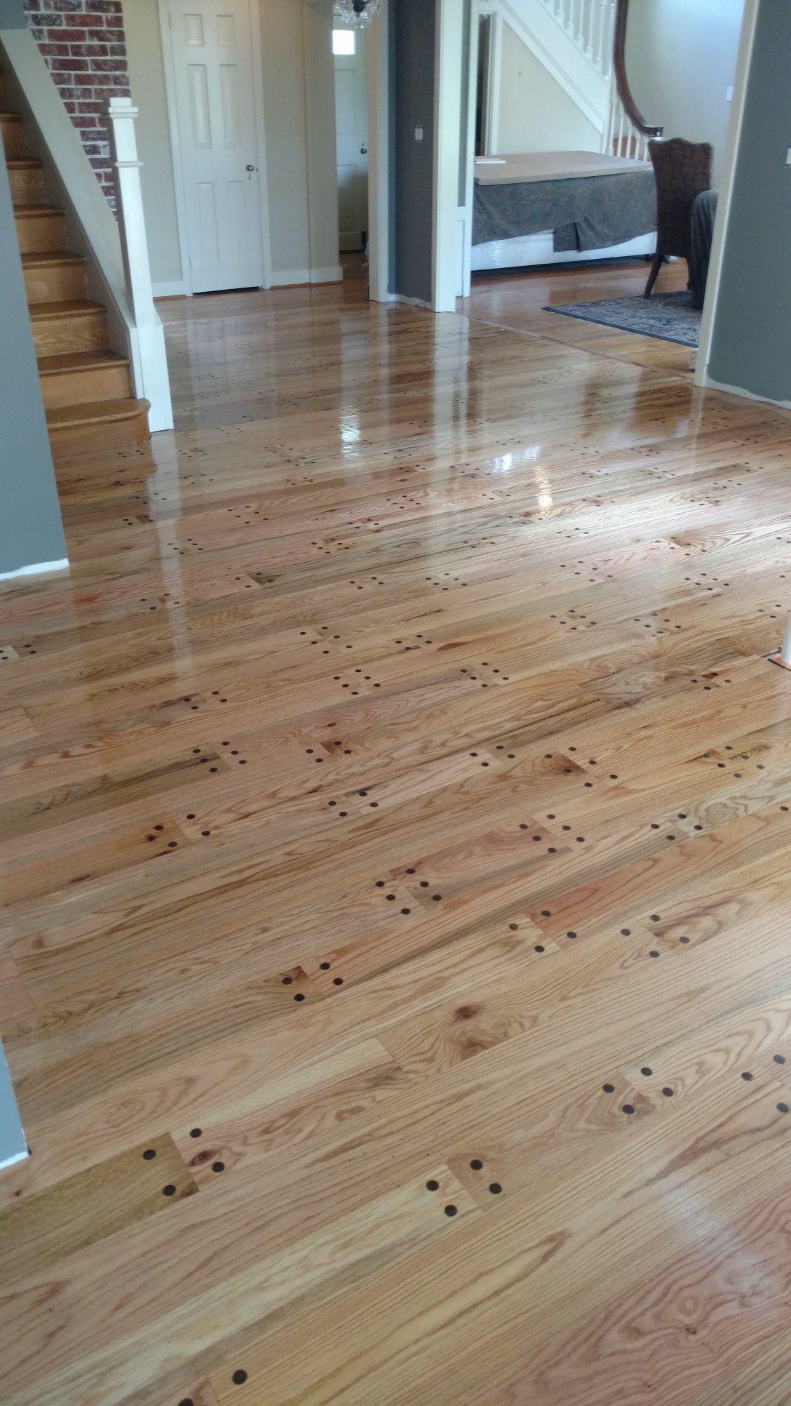 A wooden floor with a staircase in the background