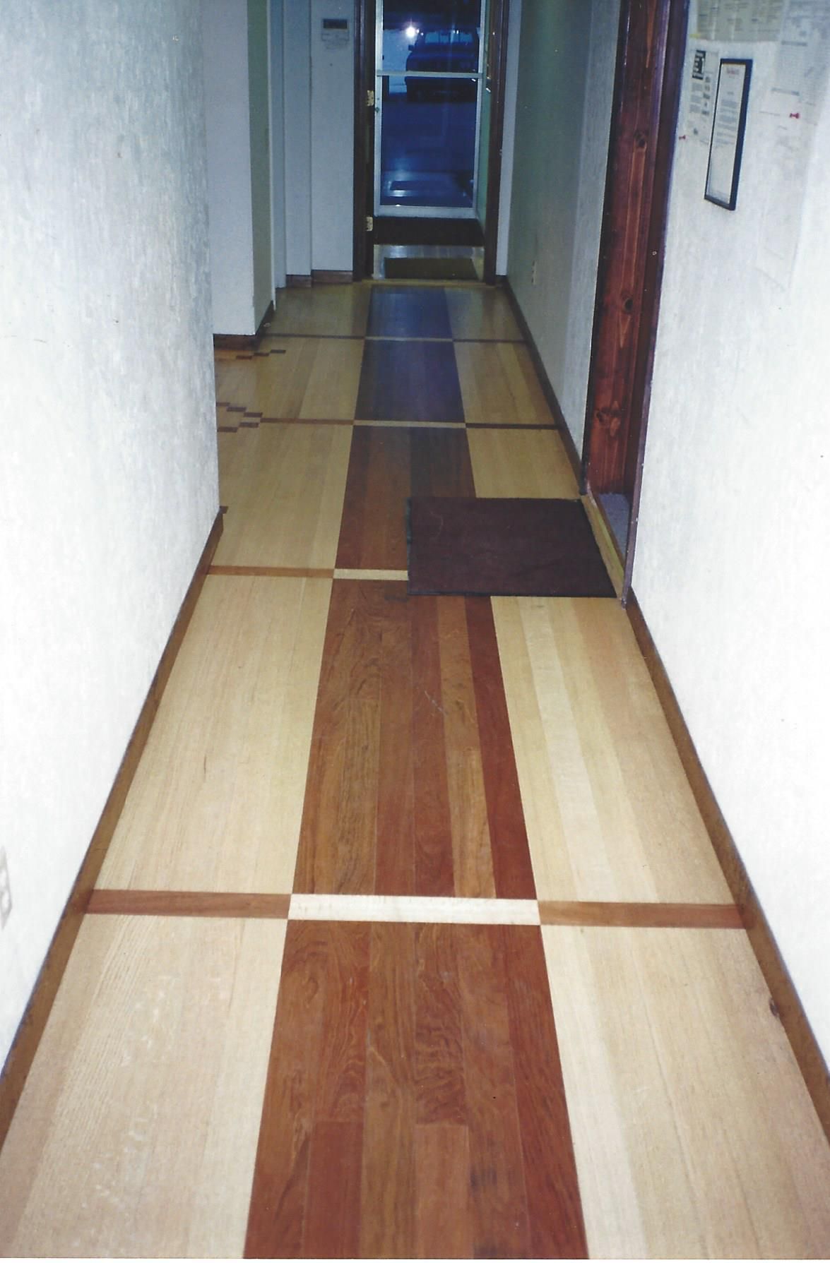 A hallway with a striped wooden floor