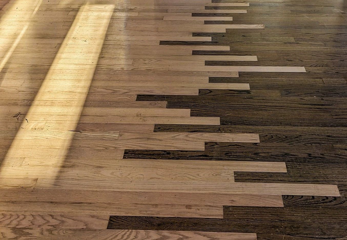 A wooden floor with a piano keyboard pattern on it