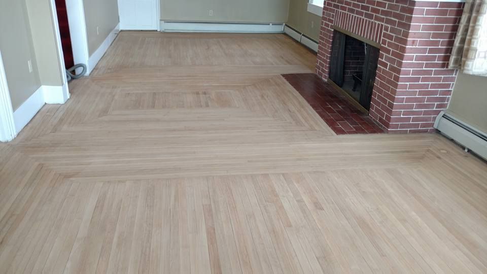 A living room with hardwood floors and a fireplace