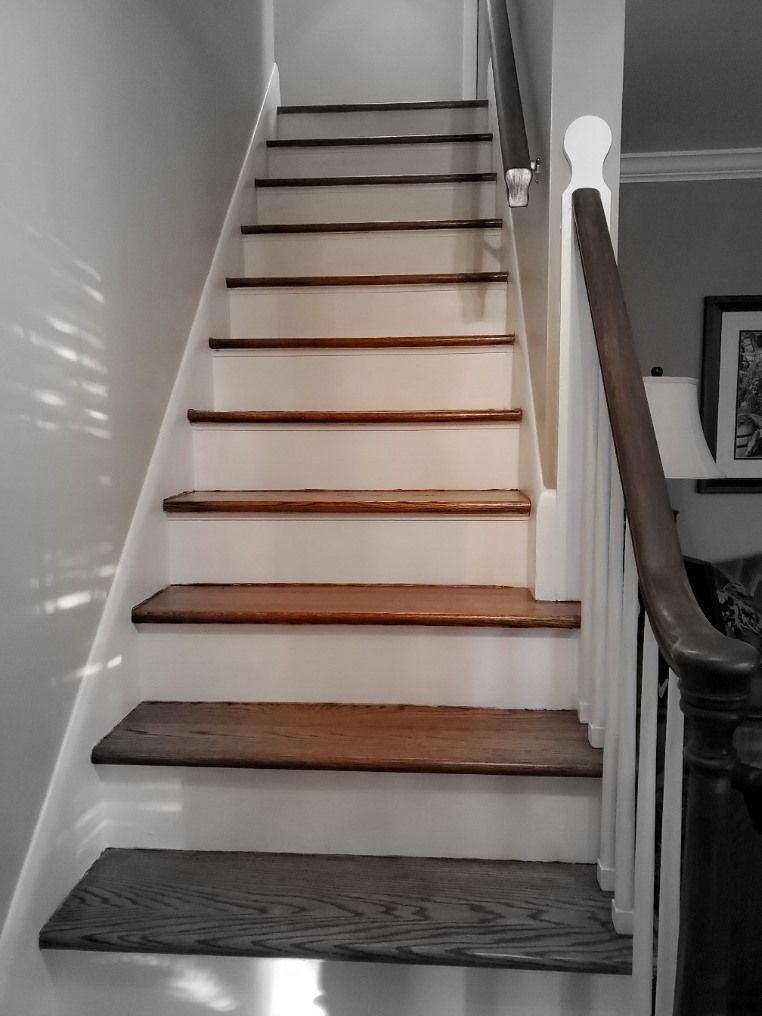 A staircase with wooden steps and a white railing