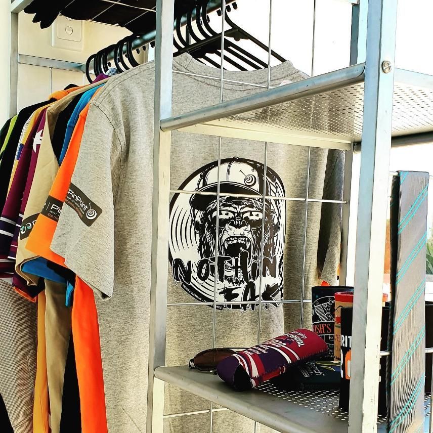 a Gray T-shirt With a Picture of a Man on It is Hanging on a Rack — Pinpoint In Alice Springs, NT