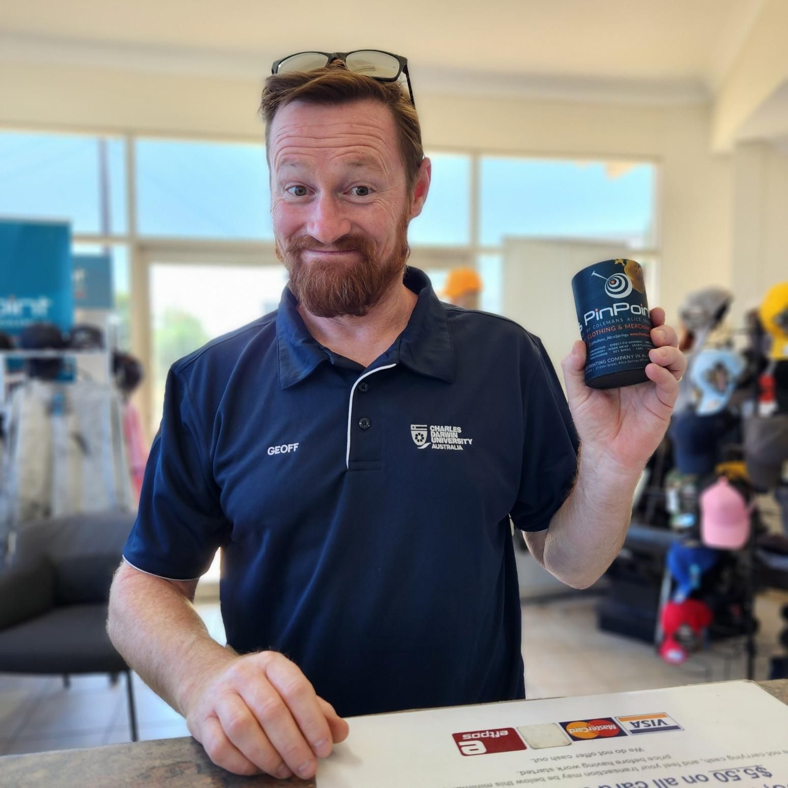 a Man in a Blue Shirt is Holding a Cell Phone — Pinpoint In Tennant Creek, NT