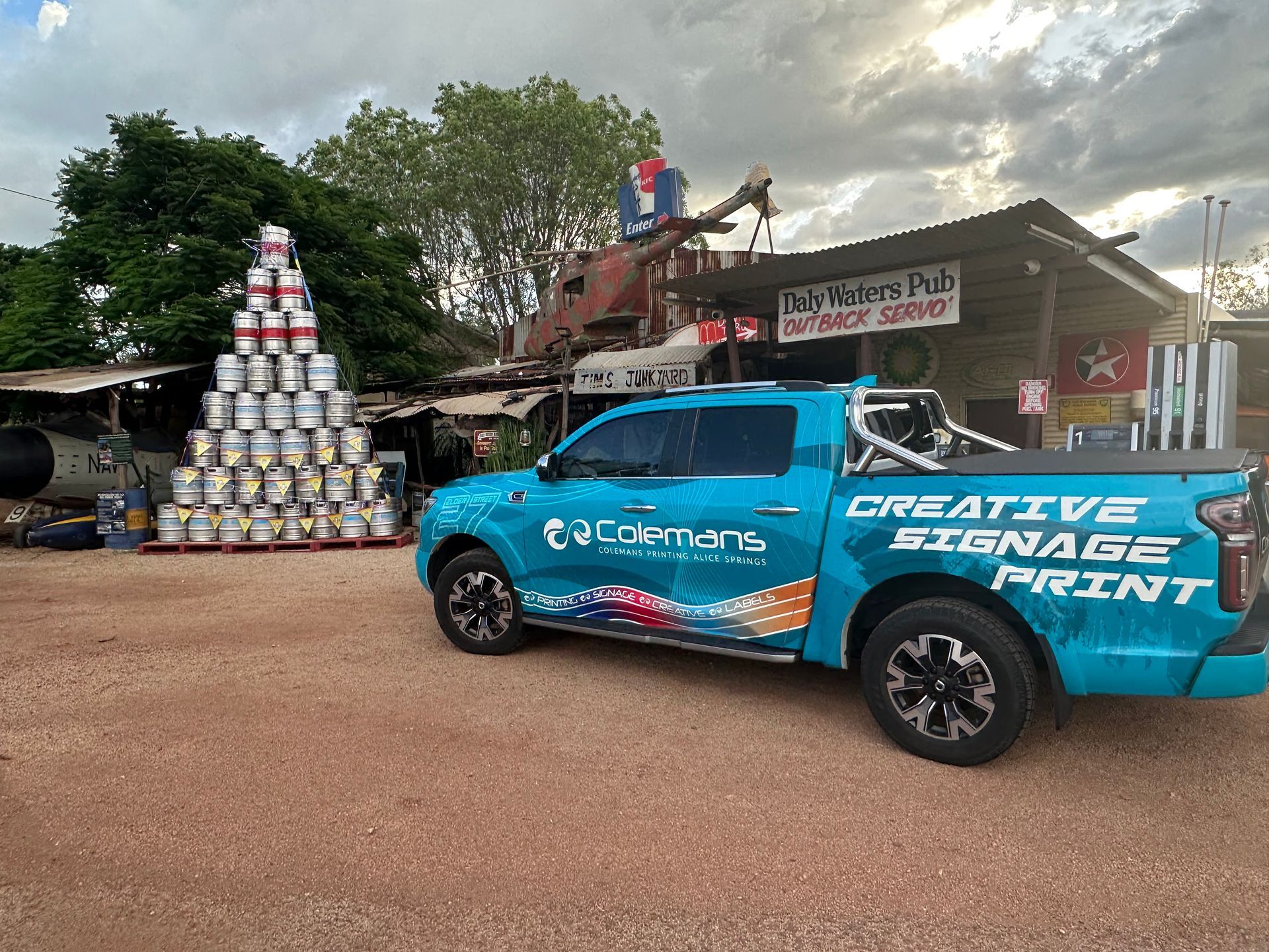 a Group of People Standing Around a Counter With a Dog — Pinpoint In Alice Springs, NT