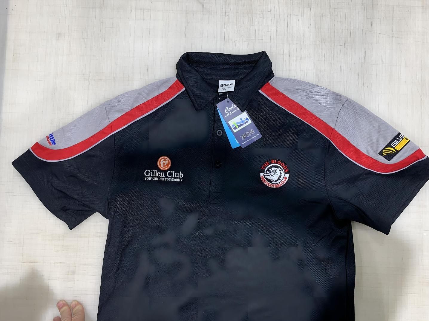 a Black Polo Shirt With a Tag on It — Pinpoint In Darwin, NT