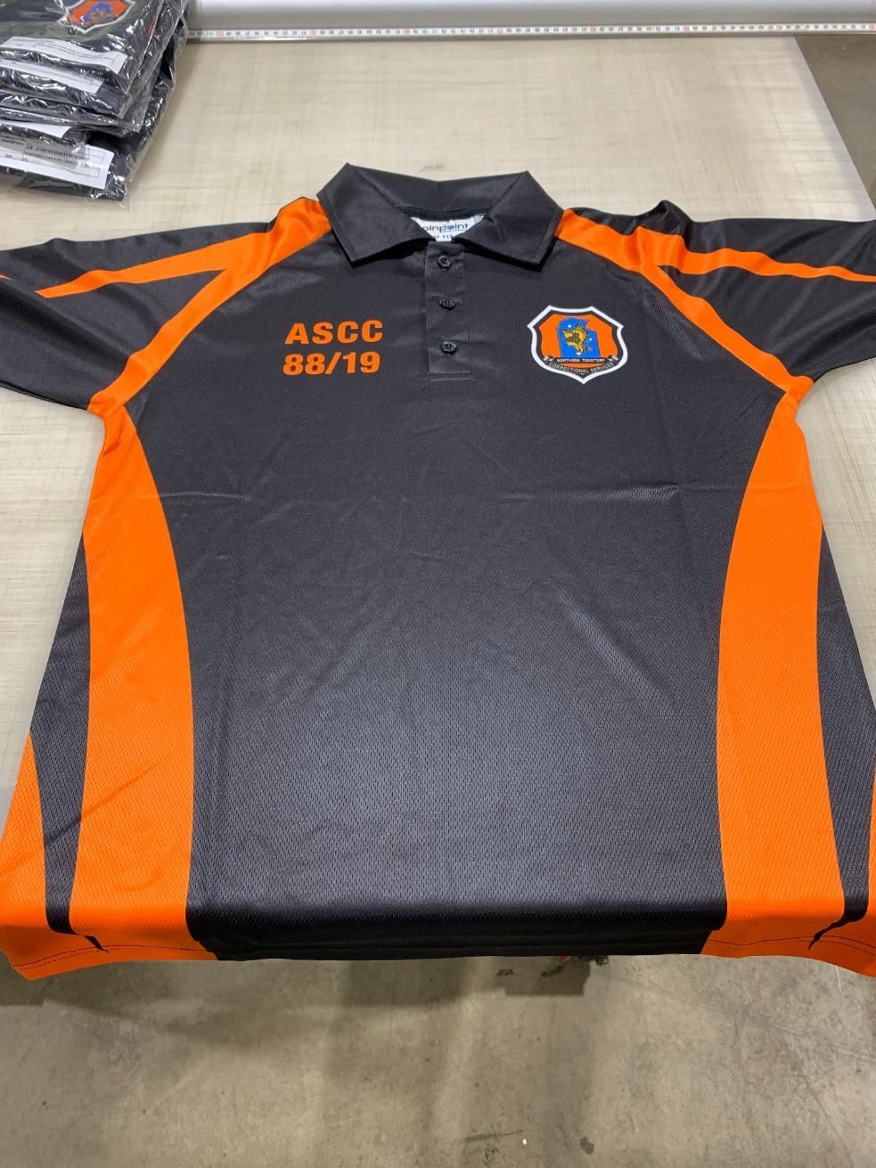 a Black and Orange Polo Shirt That Says Asco on It — Pinpoint In Darwin, NT