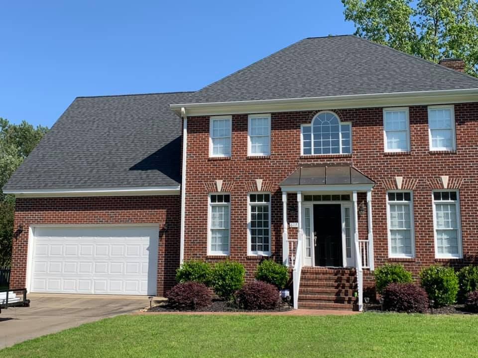 A large brick house with a white garage door