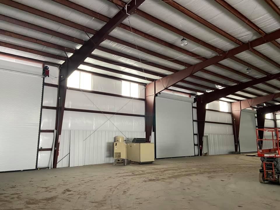 An empty warehouse with a ladder in the middle
