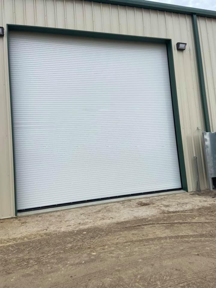 A white garage door is sitting on the side of a building.