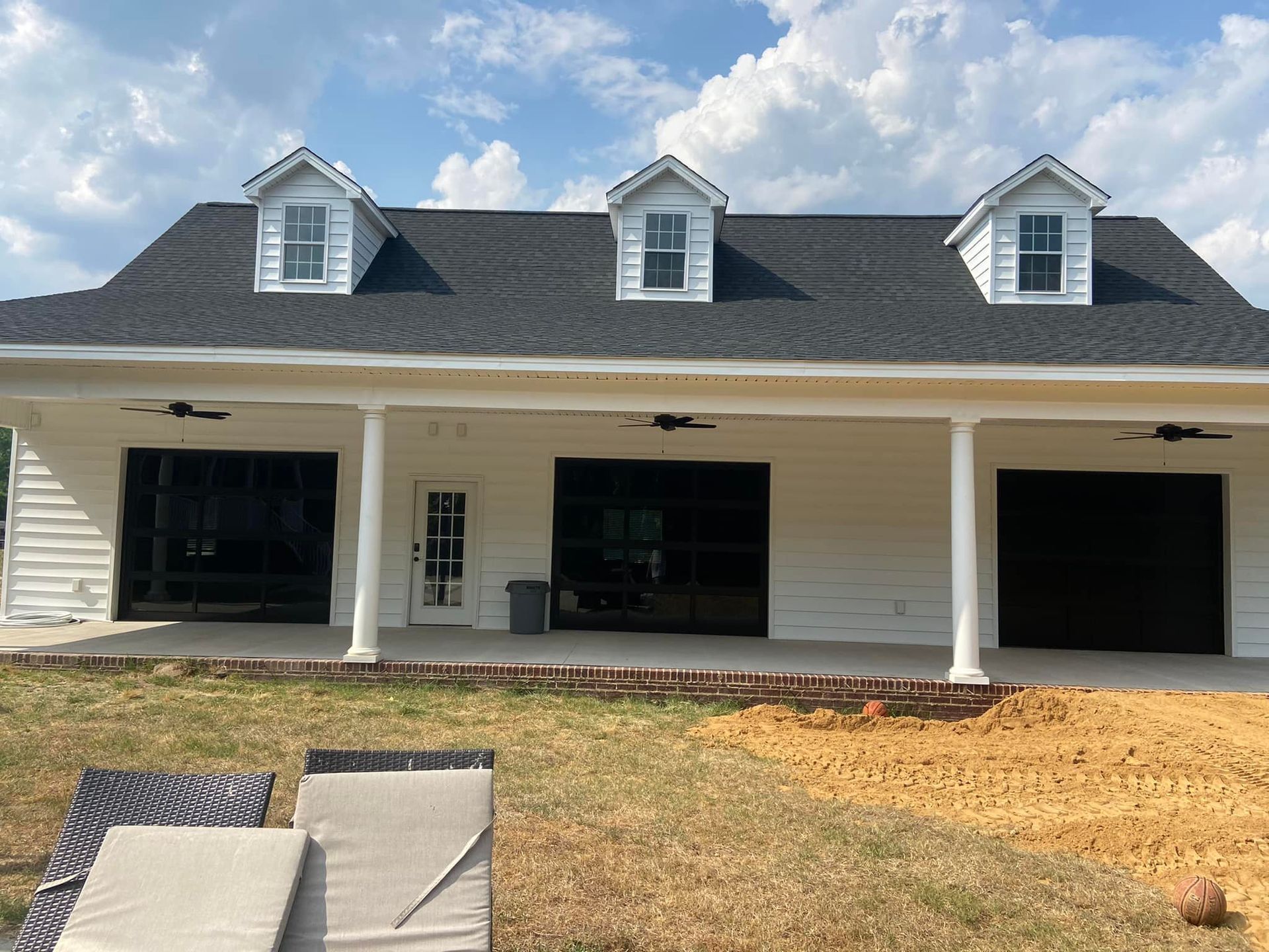 A large white house with a black roof