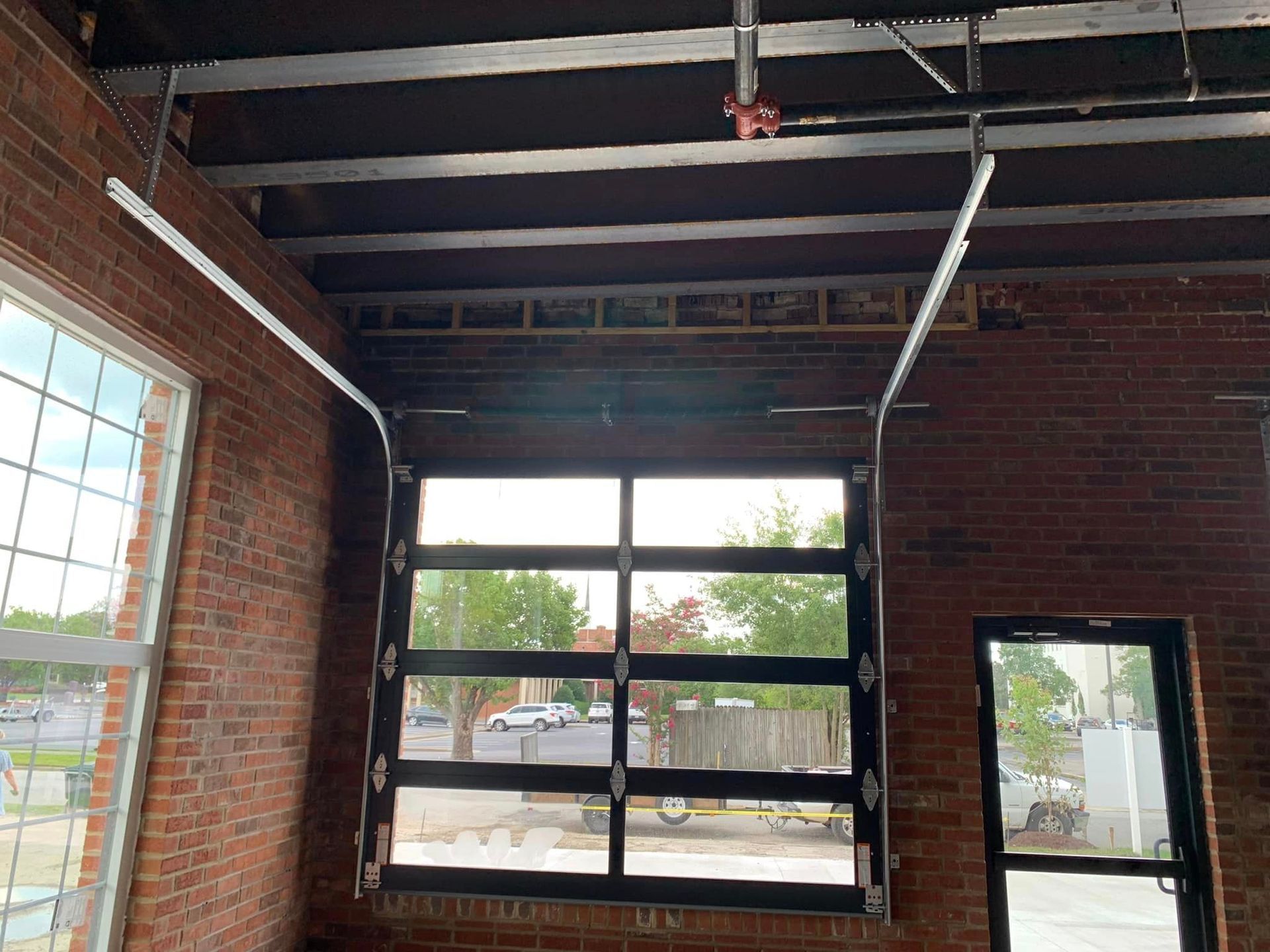 A brick building with a garage door and a window