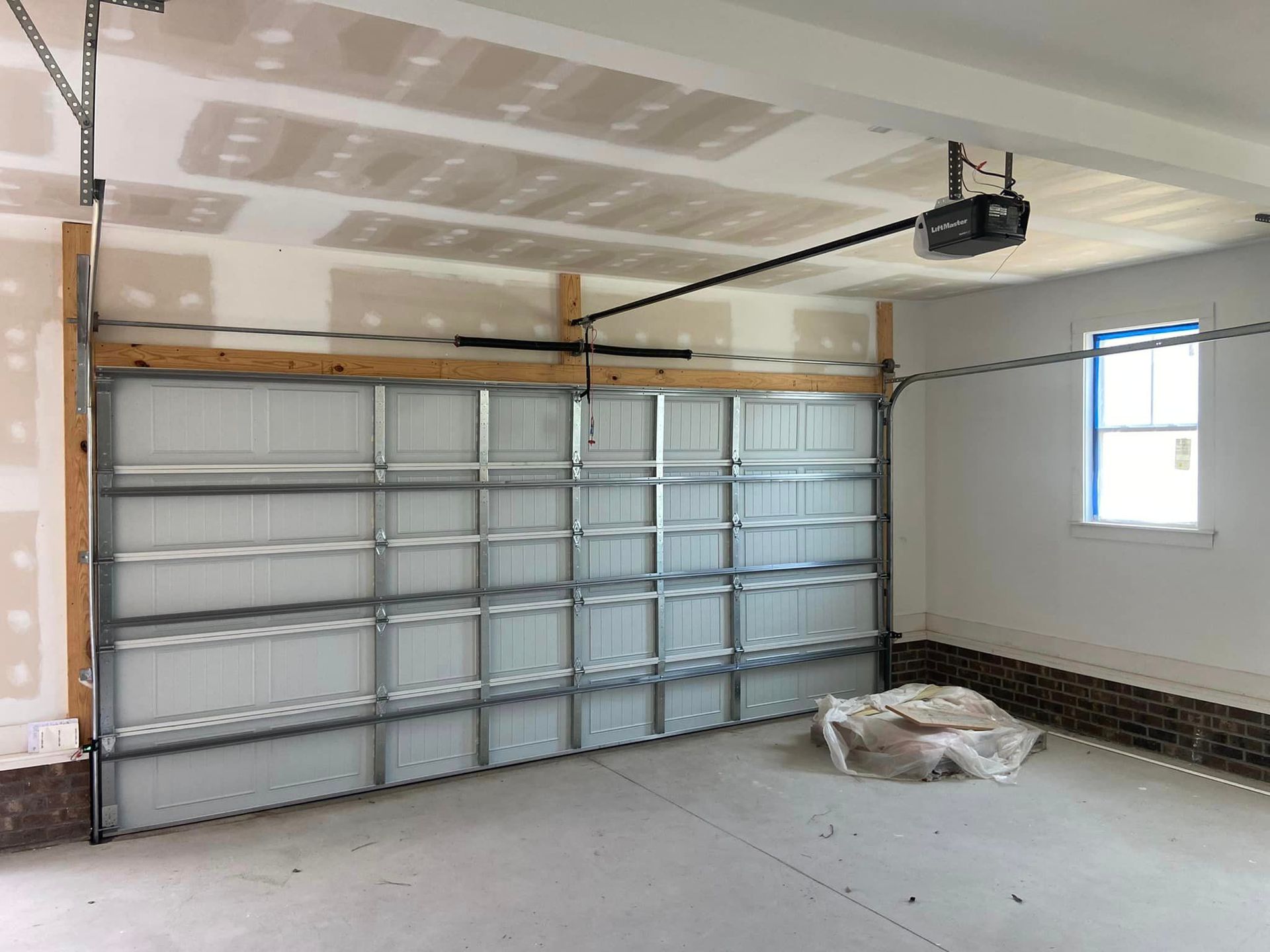 A garage with a garage door open and a window.