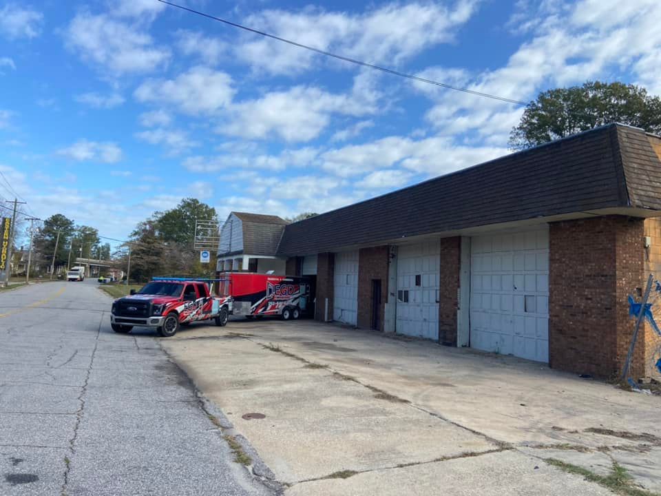 A couple of trucks parked in front of a building.