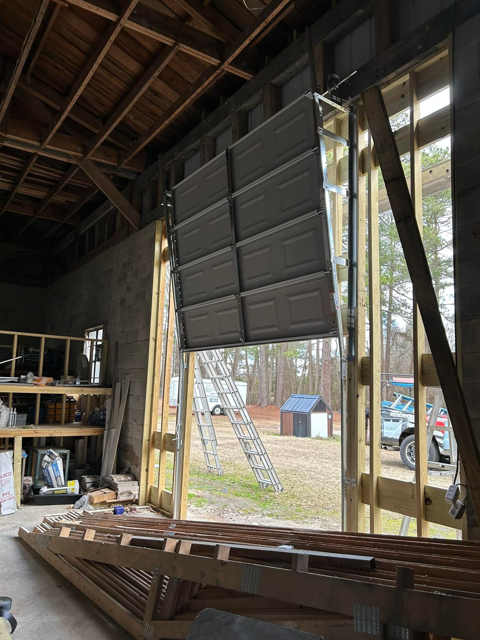 A garage door is open in a building under construction.