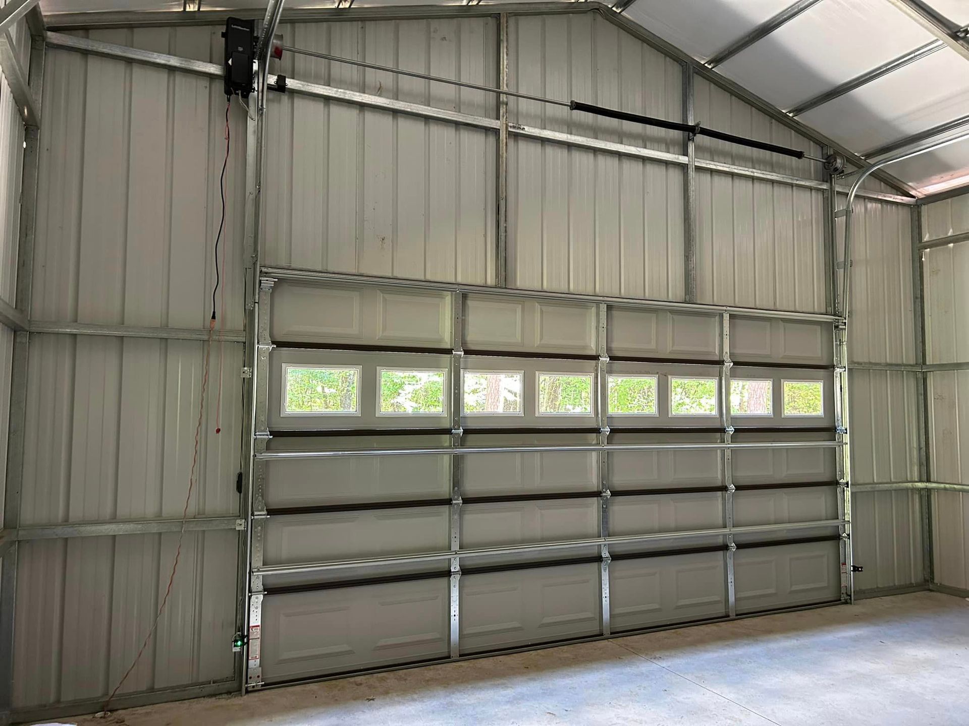 A garage with a large garage door and a window.