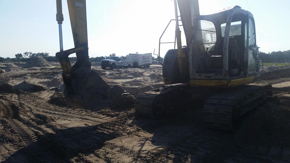 An excavator working on a construction site on a sunny day.