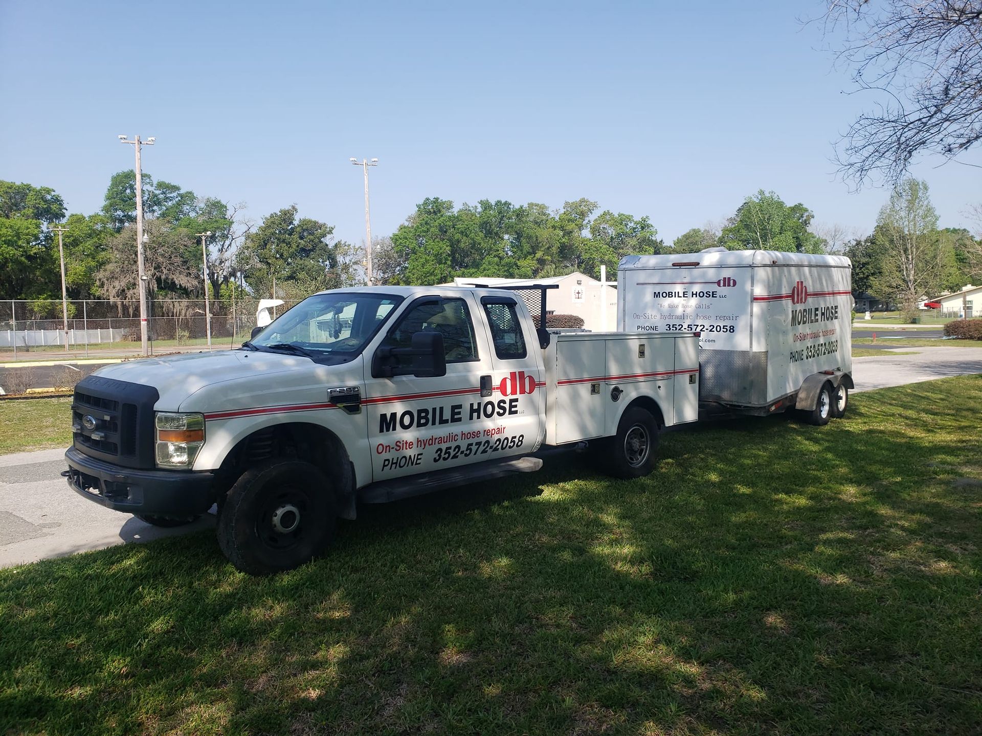 White truck and trailer labeled 