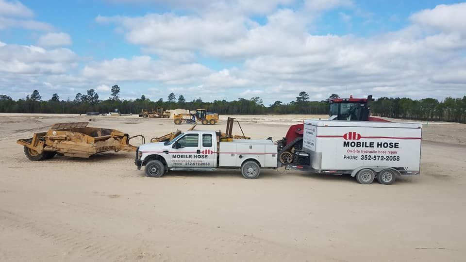 White truck towing a trailer with 