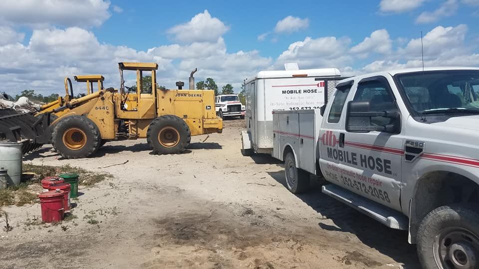 Yellow loader and white truck with 