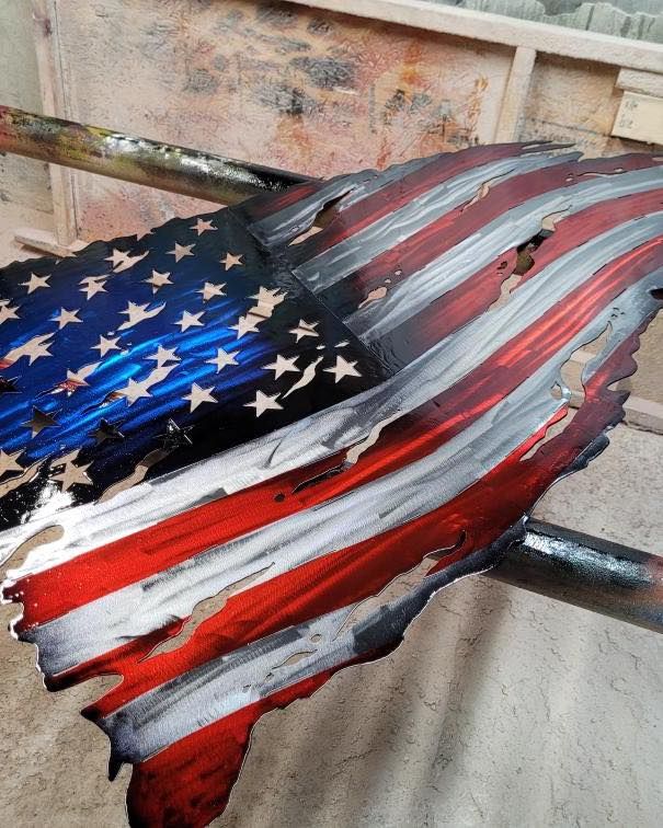 A painting of an american flag is sitting on a table.