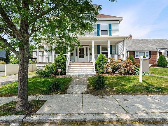 A house with a brick driveway leading to it