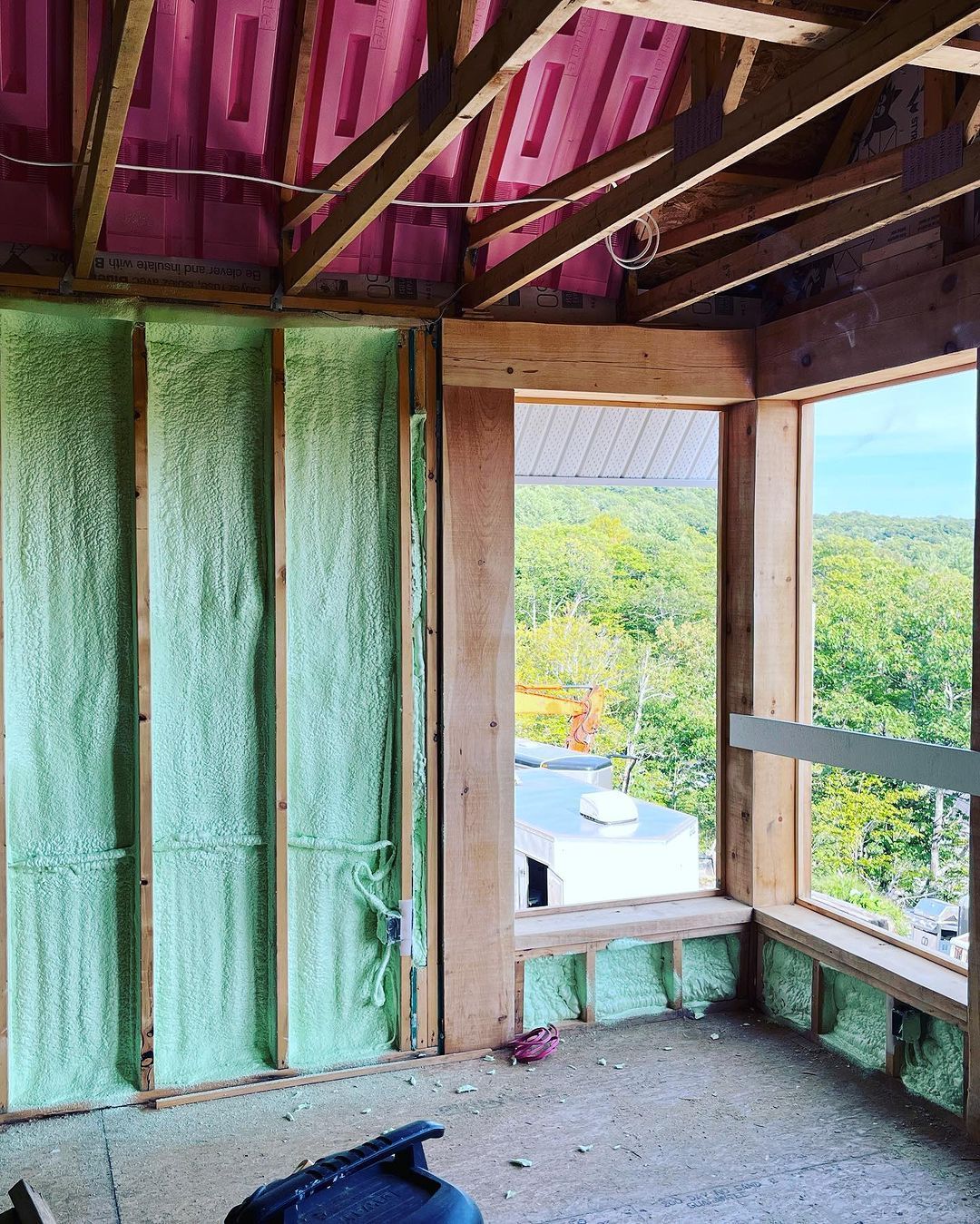 A room with a window and foam insulation on the walls.