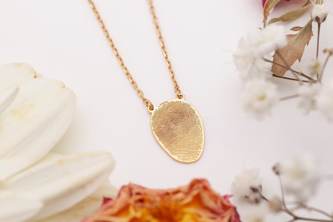 A man in a suit is sitting at a coffin at a funeral.