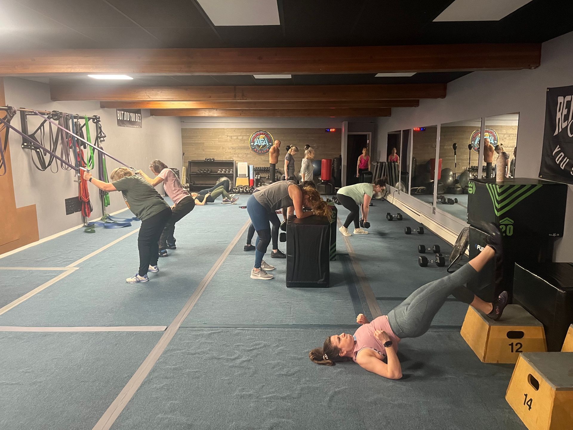 A shirtless man is running on a treadmill in a gym.