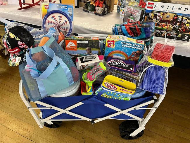 a blue wagon filled with toys and a bag