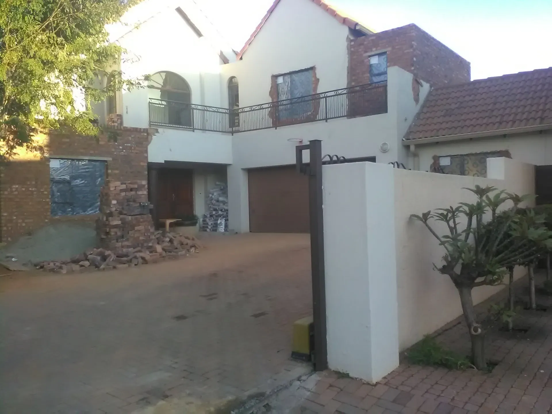 A large white house with a brown garage door