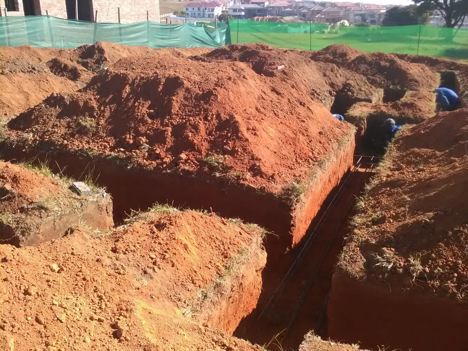 A pile of dirt is being dug up in a construction site