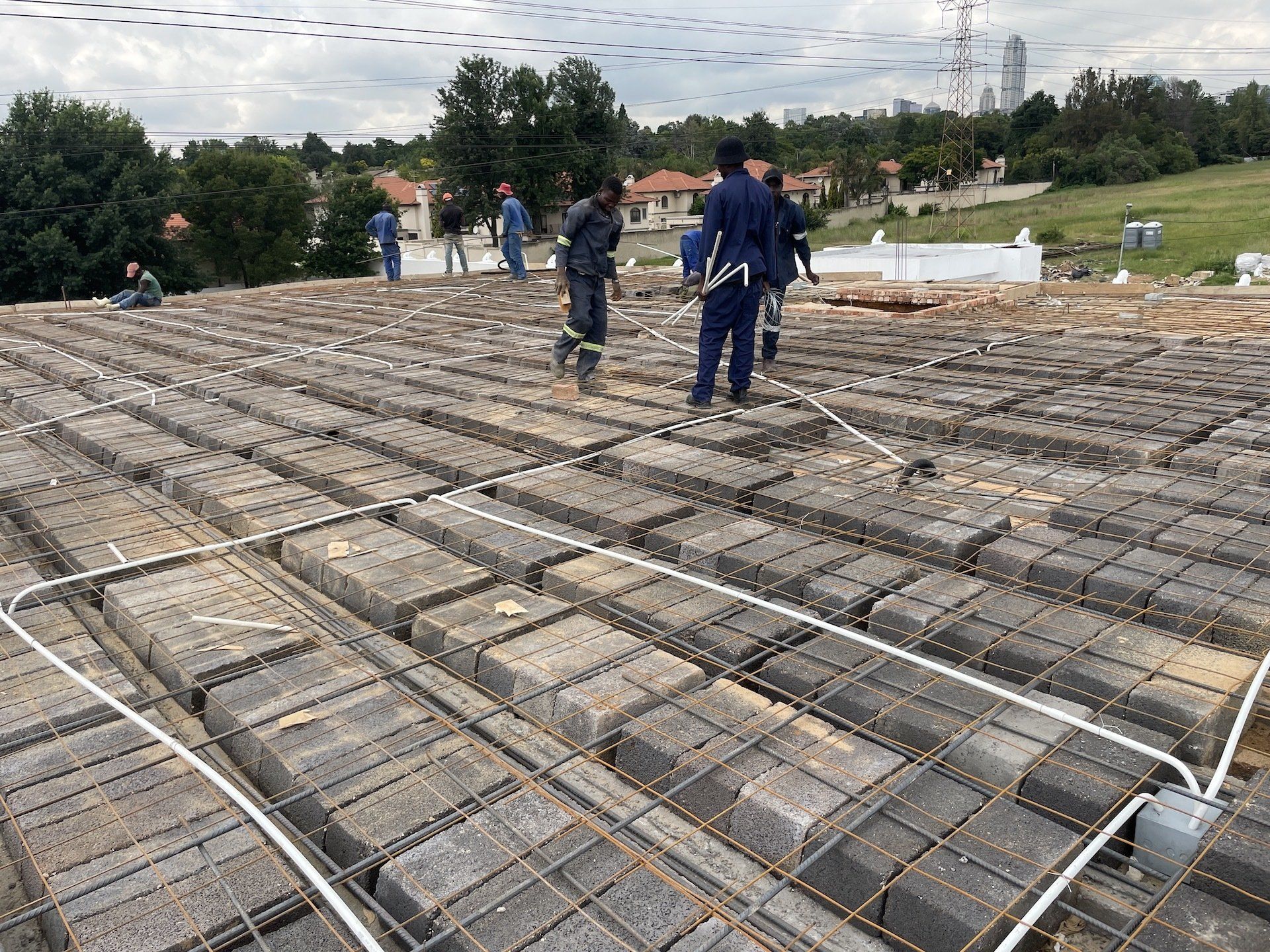 A group of construction workers are working on a roof.