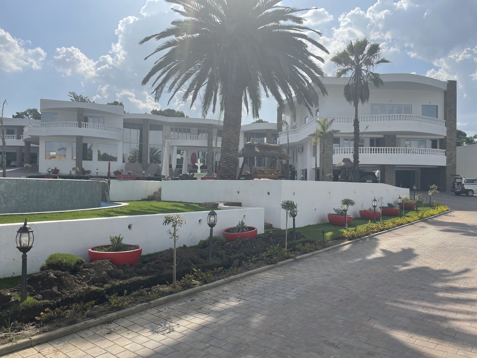 A large white house with palm trees in front of it