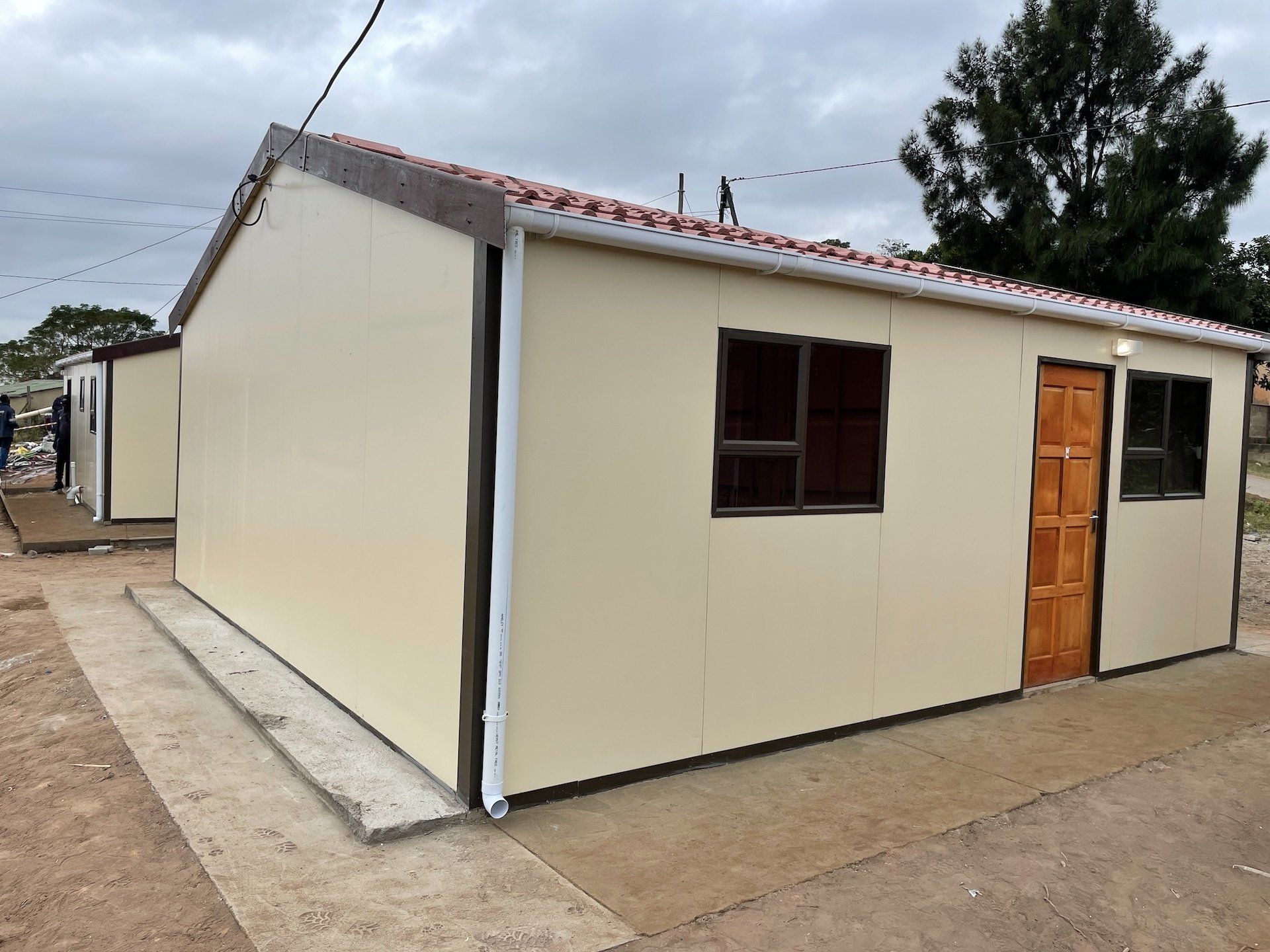 A small house with a red tiled roof and a door