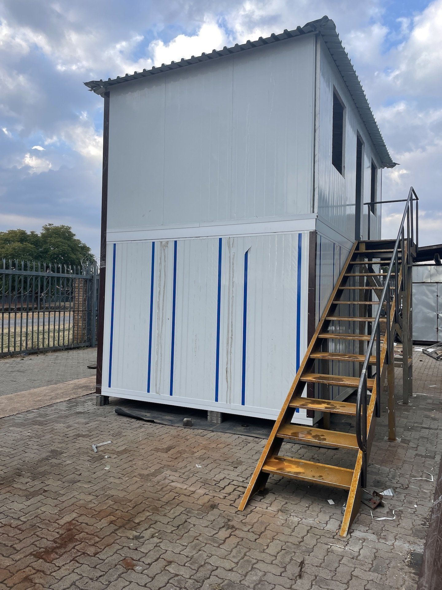 A small white building with stairs leading up to it.