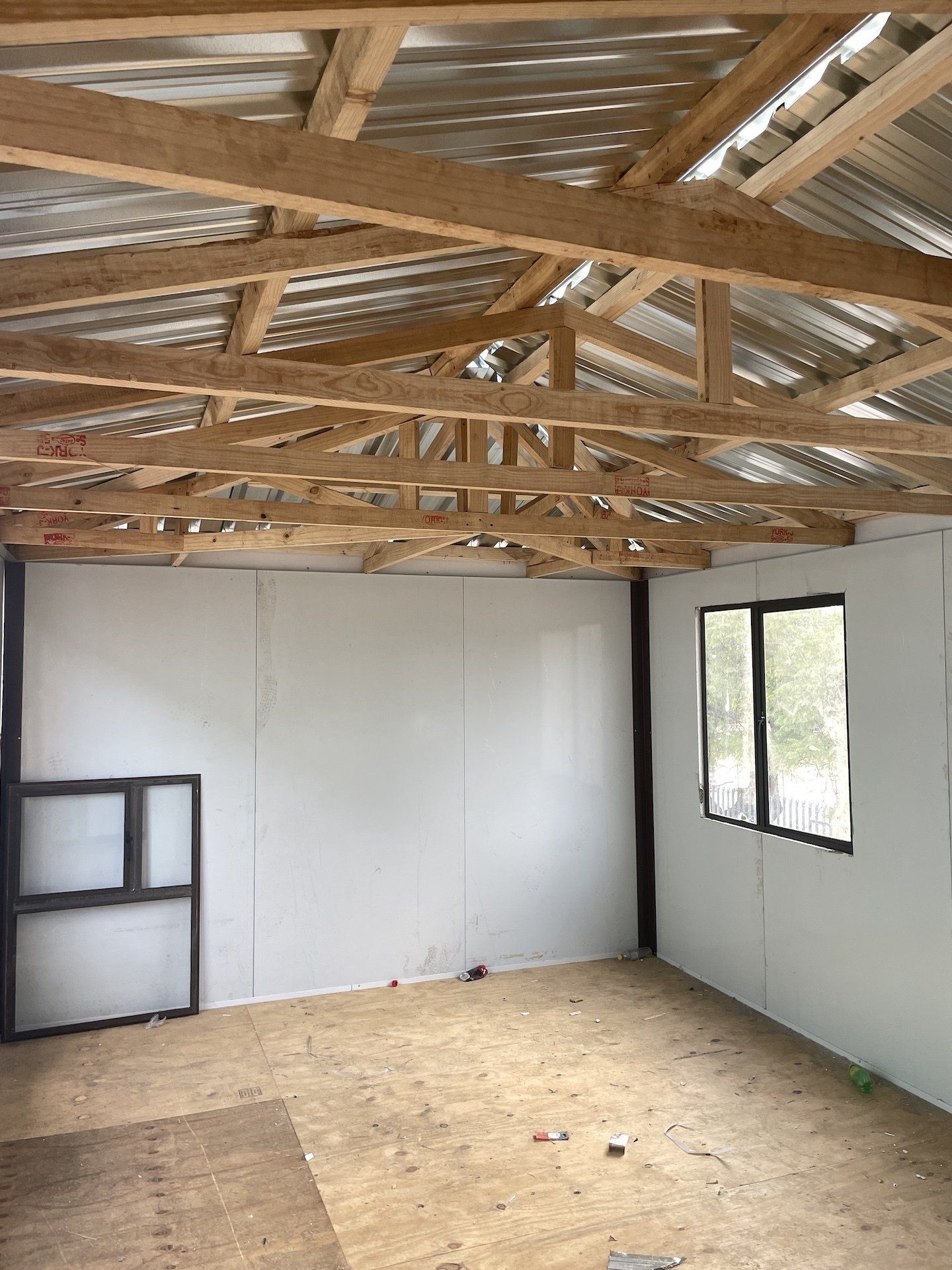 A room with a wooden ceiling and a metal roof.