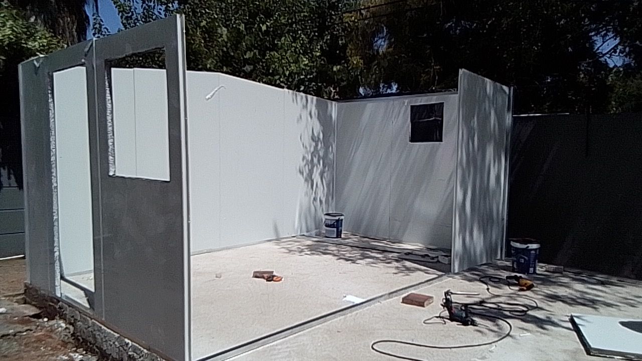 A building is being built with white walls and a window.