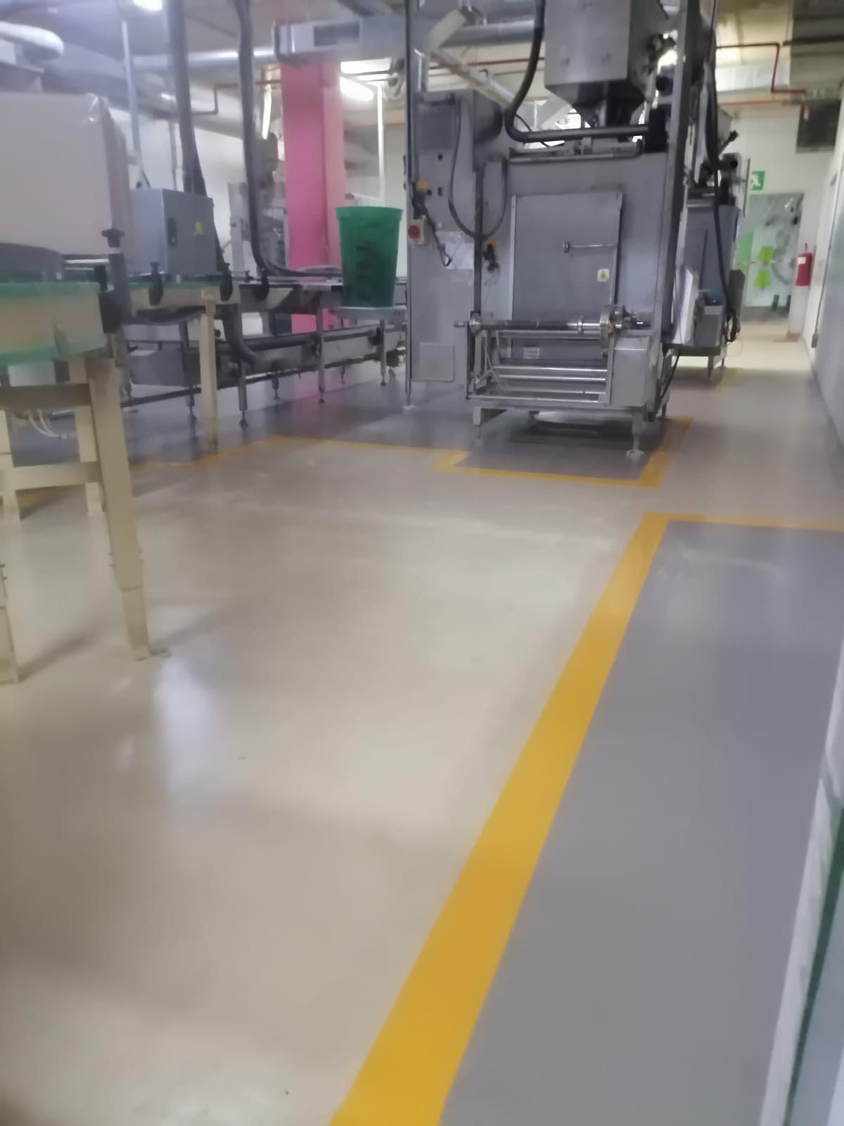 There is a yellow line on the floor in a factory.