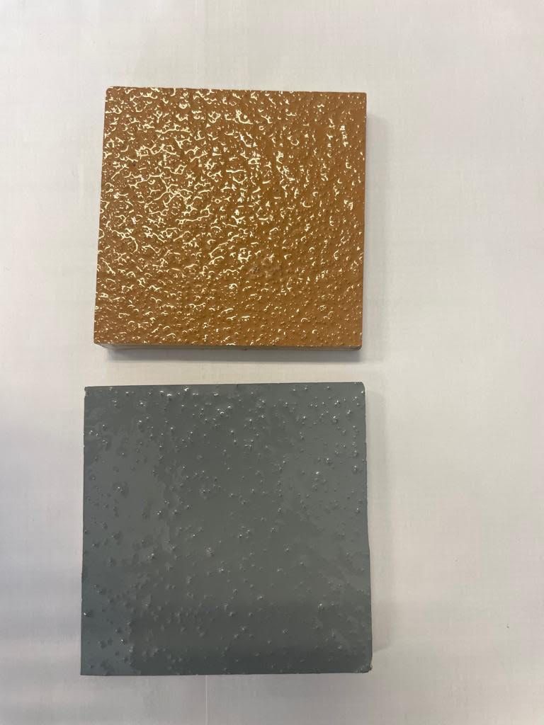 Two squares of different colors are sitting on a white surface