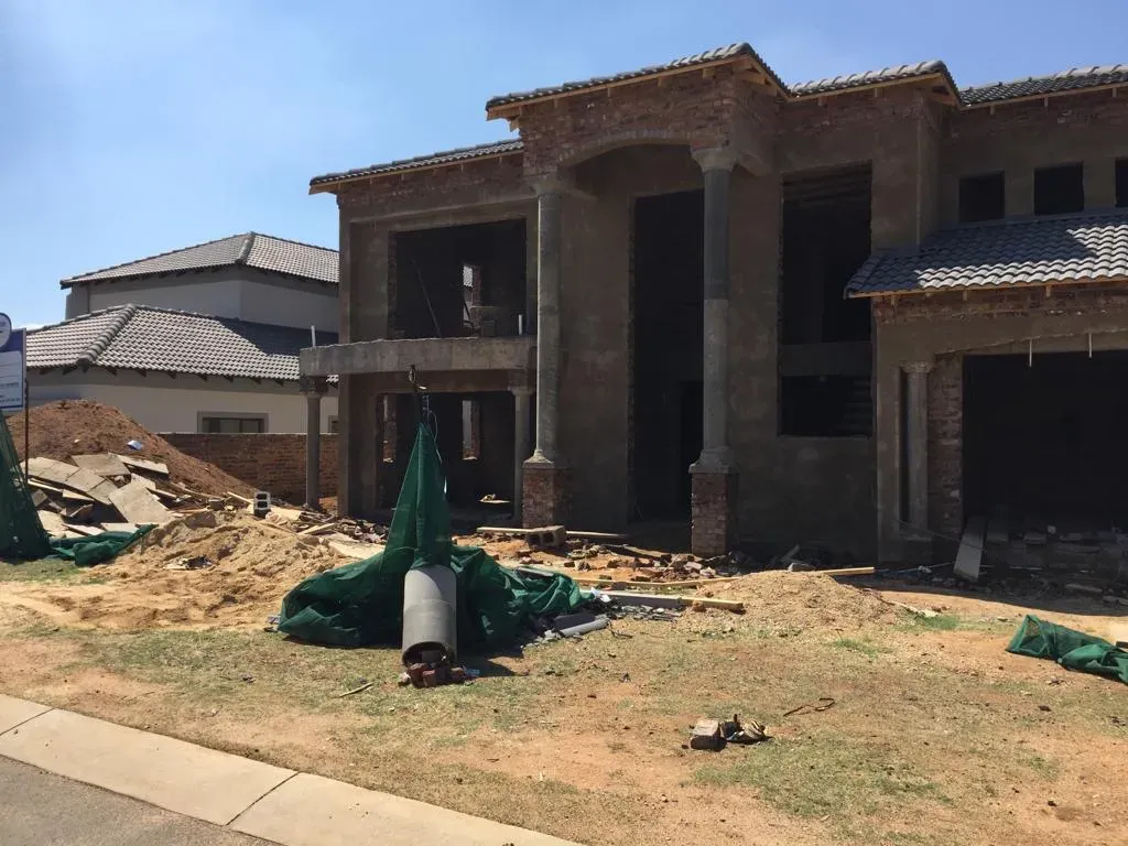 A large house is being built in a residential area.