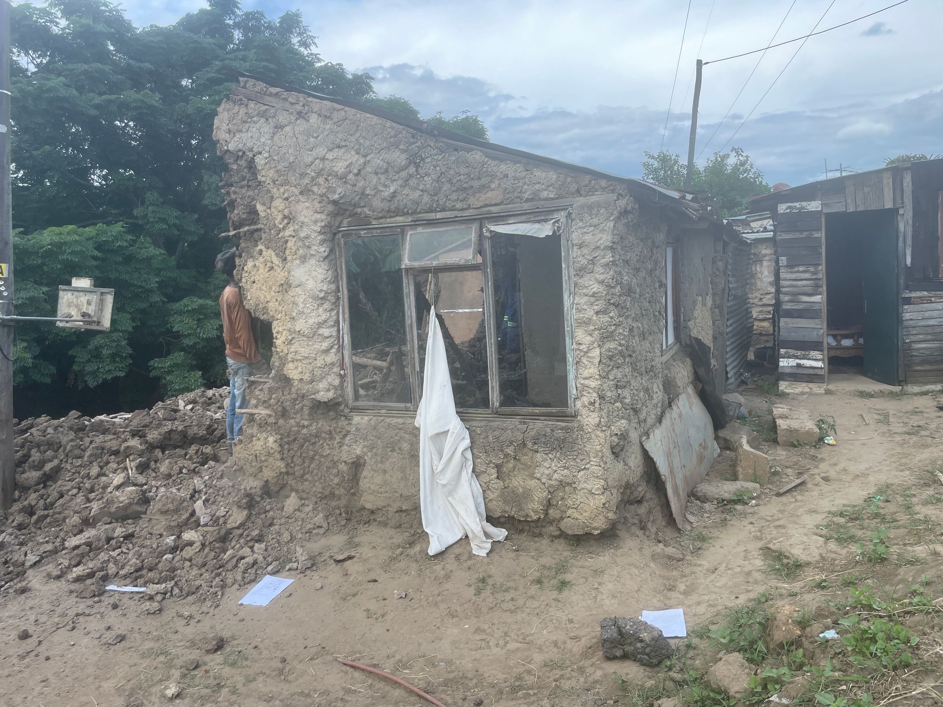 A man is standing in front of a very old building.
