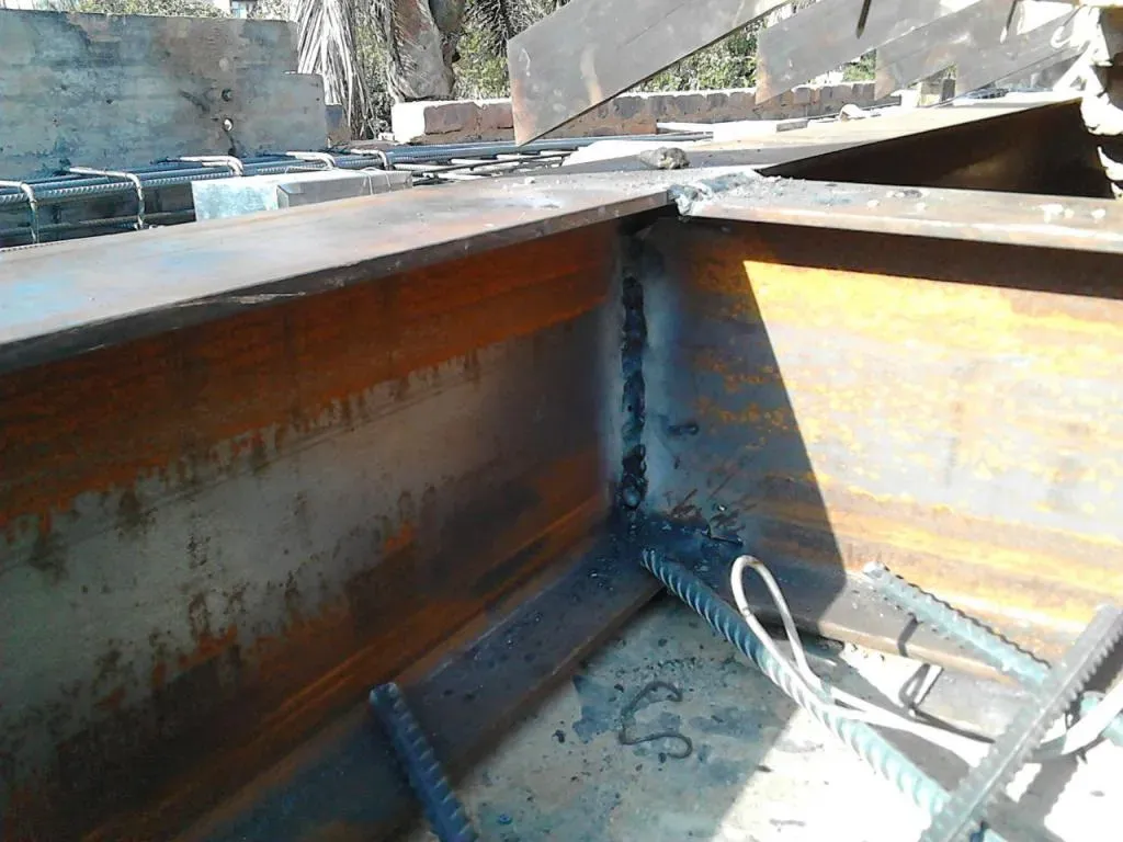 A rusty metal beam is sitting on the ground