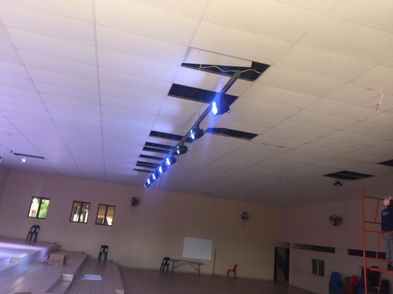 A large room with a ceiling that has a few lights on it