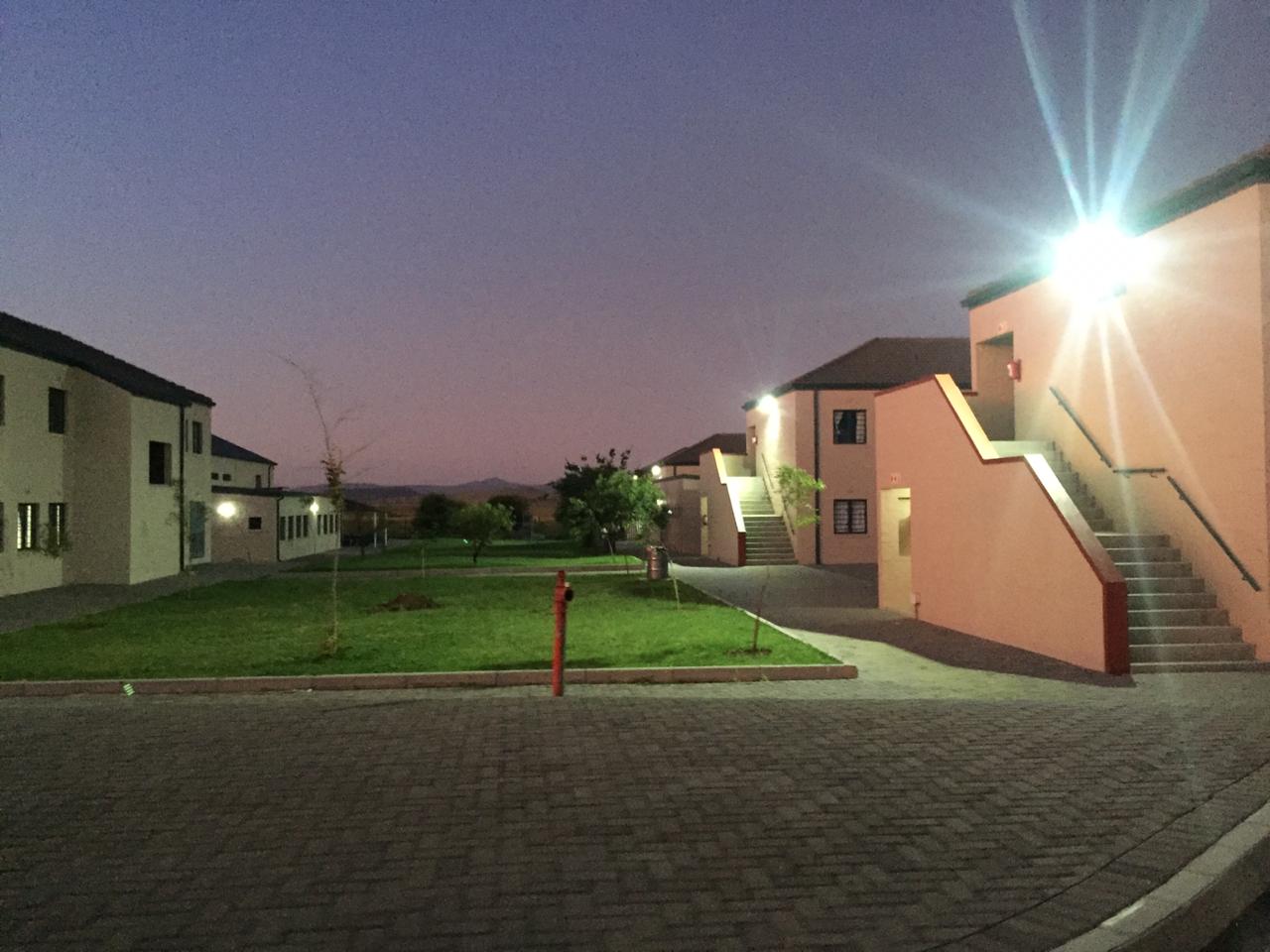 A row of houses are lit up at night