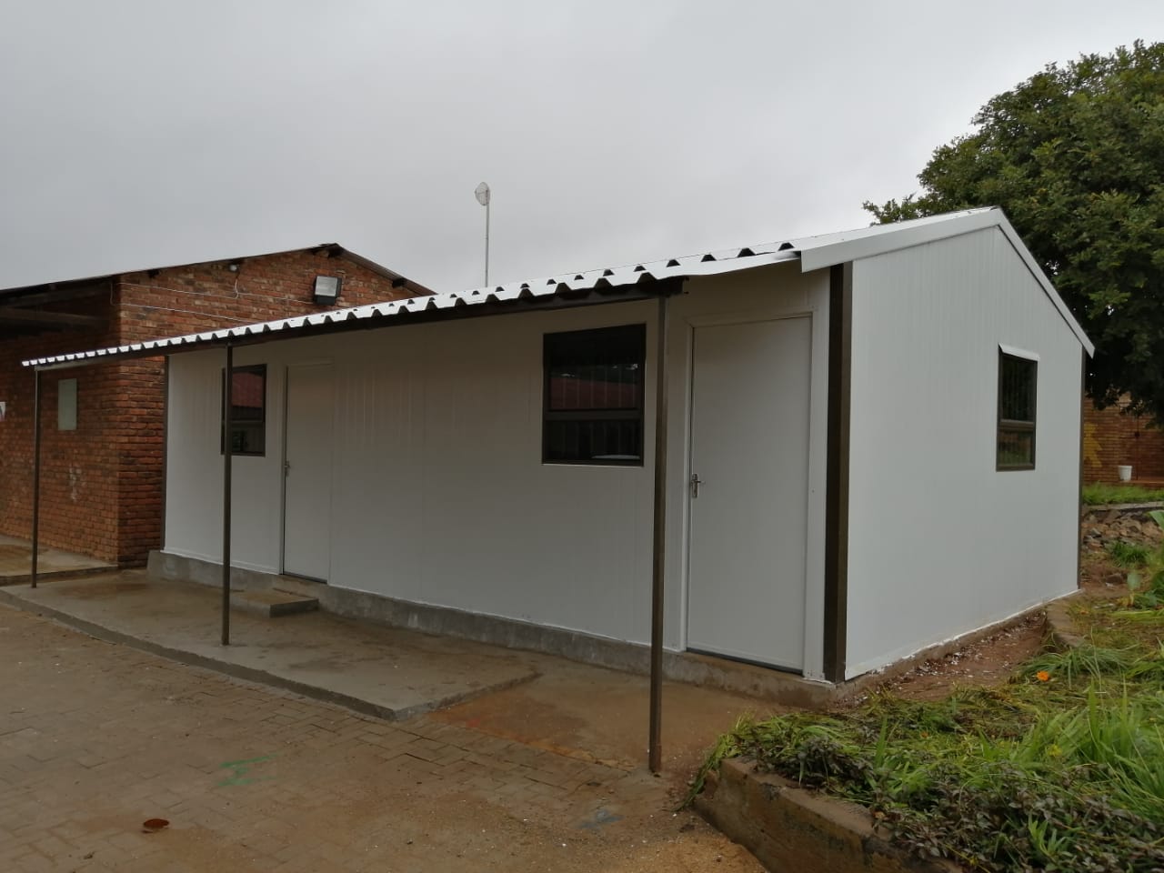 A small white house with a metal roof