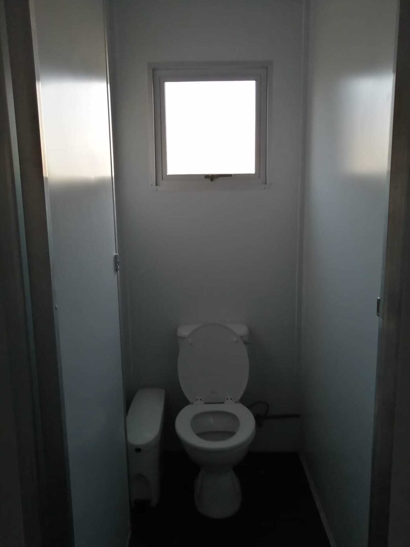 A bathroom with a toilet and a window