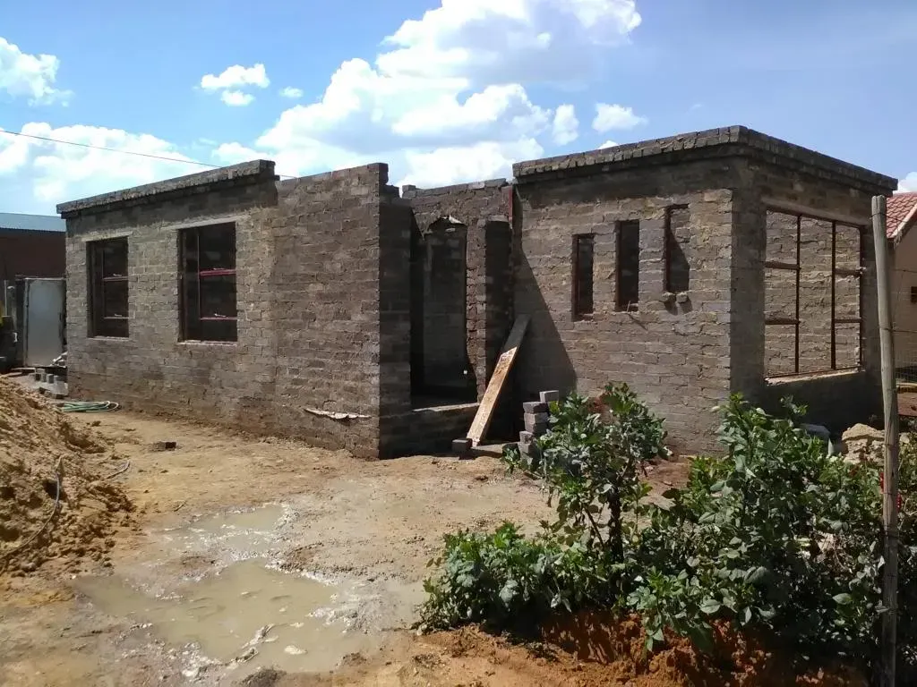 A brick building under construction with a lot of windows